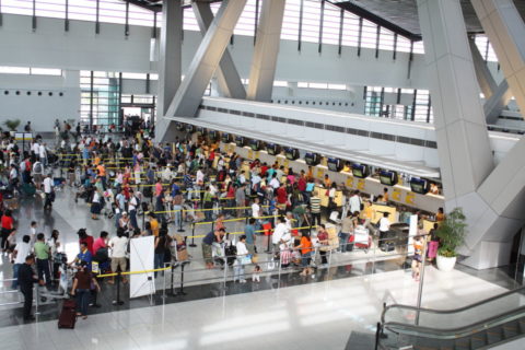 Crowds of passengers wait in line at Terminal 3 of Manila's NAIA