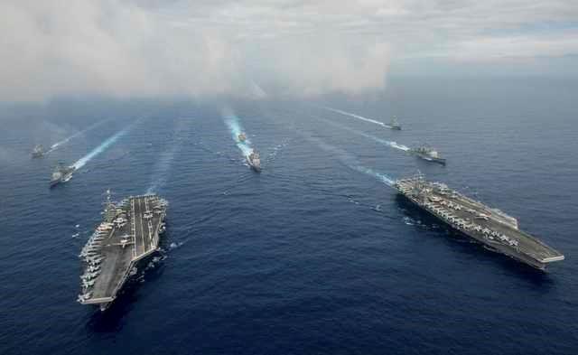 Chinas, chinese, The Nimitz-class aircraft carriers USS John C. Stennis (CVN 74), and USS Ronald Reagan (CVN 76) (R) conduct dual aircraft carrier strike group operations in the U.S. 7th Fleet area of operations in support of security and stability in the Indo-Asia-Pacific in the Philippine Sea on June 18, 2016. Courtesy Jake Greenberg/U.S. Navy/Handout via REUTERS