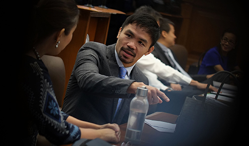 Senator Manny Pacquiao in a huddle with Senator Loren Legarda