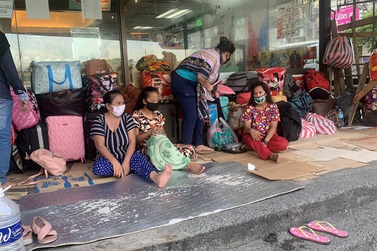Stranded passengers at NAIA Terminal 3 sleep in sidewalk