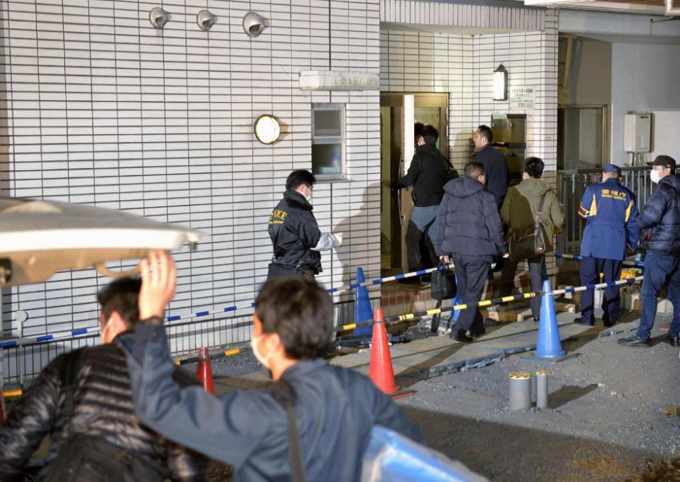 Police officers arrive for investigation of the apartment of abduction suspect Kabu Terauchi in Tokyo Monday, March 28, 2016. Japanese police captured the 23-year-old man in an abduction case after a teenage girl escaped and ran for freedom a day earlier after being held captive in his apartment for nearly two years. Police said Monday the girl, 15, escaped from suspect Terauchis apartment Sunday while he was out shopping and called from a pay phone. She disappeared two years ago from her hometown in Saitama, near Tokyo. (Kyodo News via AP) JAPAN OUT, MANDATORY CREDIT