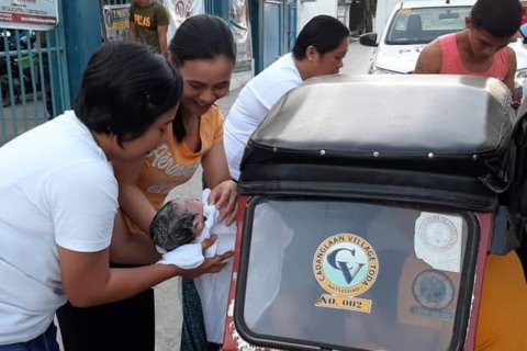 Valentine's baby woman gives birth inside tricycle