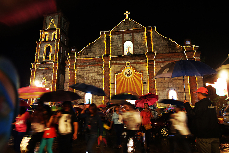 Ilocano Catholic worshippers attend the 1st of 9 days traditional Misa de Gallo (dawn mass) at St. Peter and Paul Church in Bauang, La Union during downpour (December 16,2015) . Photo by VIC ALHAMBRA,