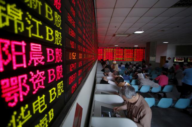 Investors look at computer screens showing stock information at a brokerage house in Shanghai, May 26, 2015. REUTERS/Aly Song/File Photo